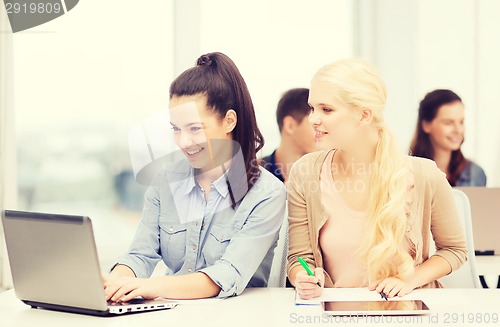 Image of students with laptop, tablet pc and notebooks