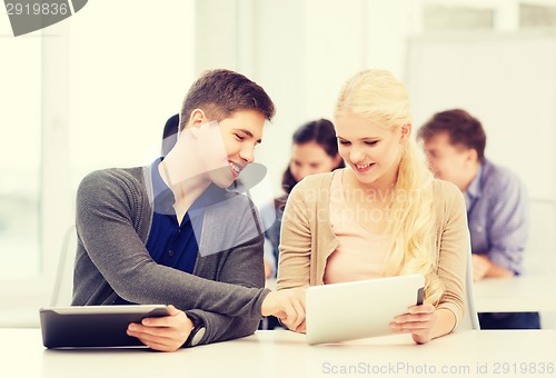 Image of students looking at tablet pc in lecture at school