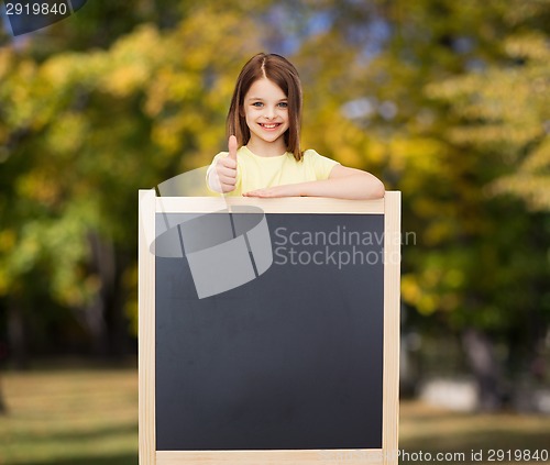 Image of happy little girl with blank blackboard