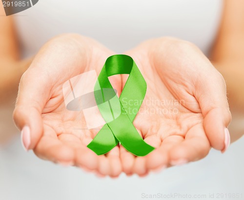 Image of hands holding green awareness ribbon