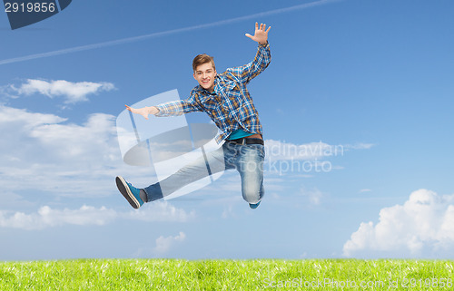 Image of smiling young man jumping in air