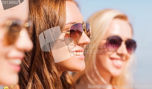Image of close up of smiling young women in sunglasses