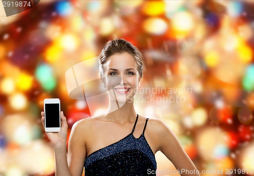 Image of smiling woman in evening dress with smartphone