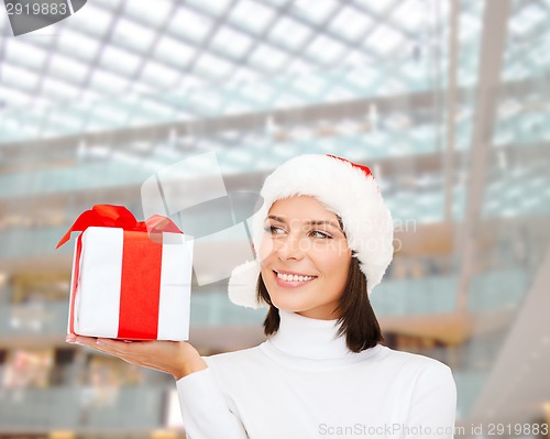 Image of smiling woman in santa helper hat with gift box