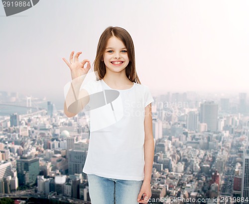 Image of smiling little girl in white blank t-shirt