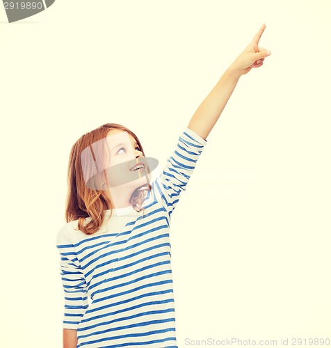 Image of smiling girl pointing at virtual screen