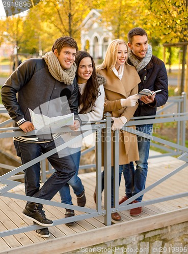 Image of group of friends with map outdoors