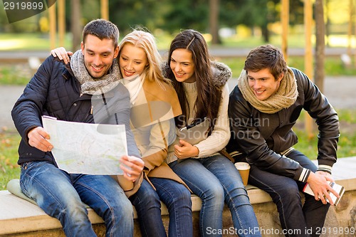 Image of group of friends with map outdoors