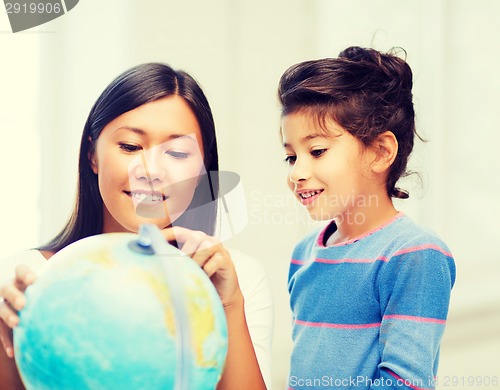 Image of mother and daughter with globe