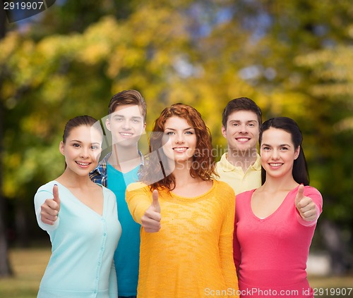 Image of group of smiling teenagers over green park