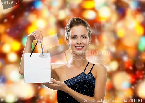 Image of smiling woman with white blank shopping bag