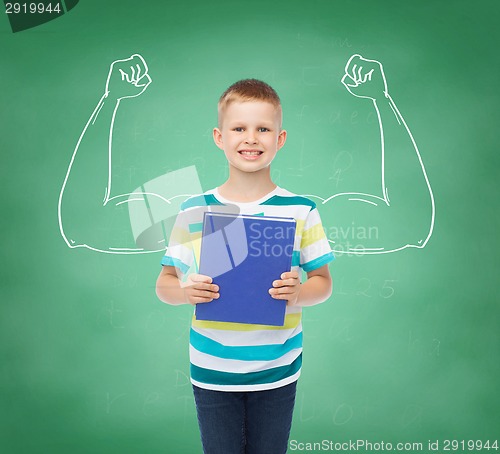 Image of smiling little student boy with blue book