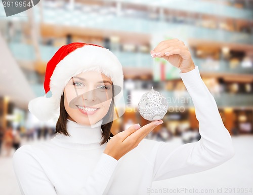 Image of woman in santa helper hat with christmas ball