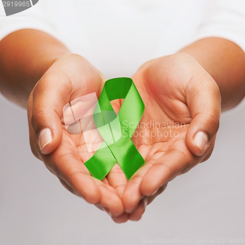 Image of hands holding green awareness ribbon