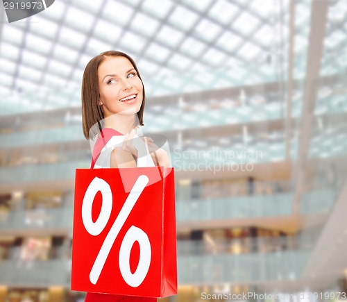 Image of woman in red dress with shopping bags