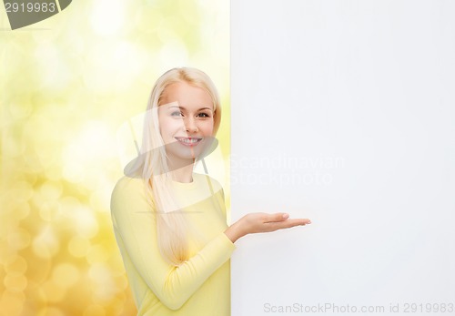 Image of smiling woman in sweater with blank white board