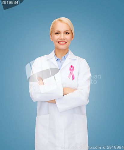 Image of smiling female doctor with cancer awareness ribbon