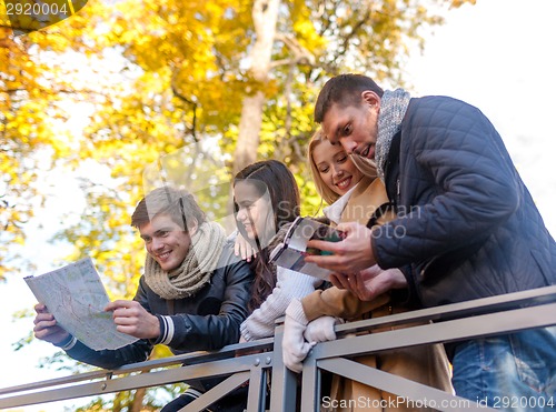 Image of group of friends with map outdoors