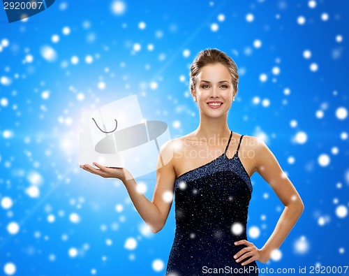 Image of smiling woman with white blank shopping bag