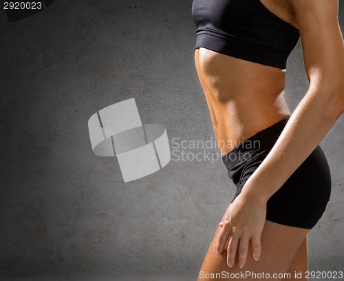 Image of close up of athletic female abs in sportswear