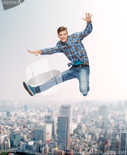 Image of smiling young man jumping in air