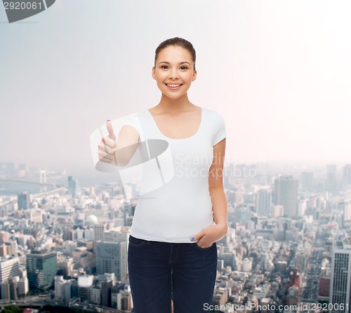 Image of smiling young woman in blank white t-shirt