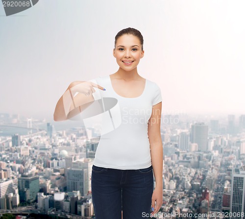 Image of smiling young woman in blank white t-shirt