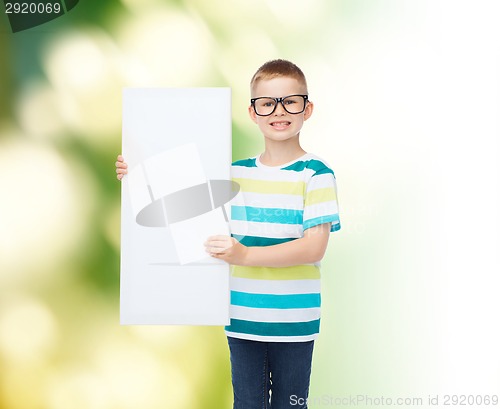 Image of smiling boy in eyeglasses with white blank board