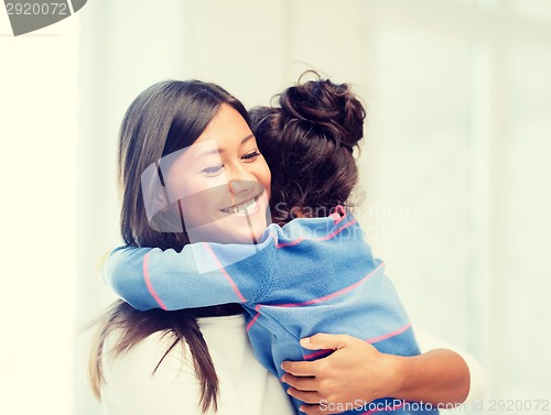 Image of hugging mother and daughter