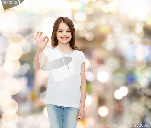 Image of smiling little girl in white blank t-shirt