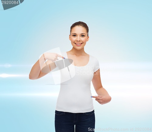 Image of smiling young woman in blank white t-shirt