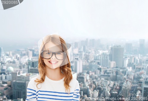 Image of smiling cute little girl with black eyeglasses