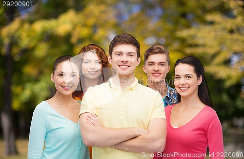 Image of group of smiling teenagers over green park