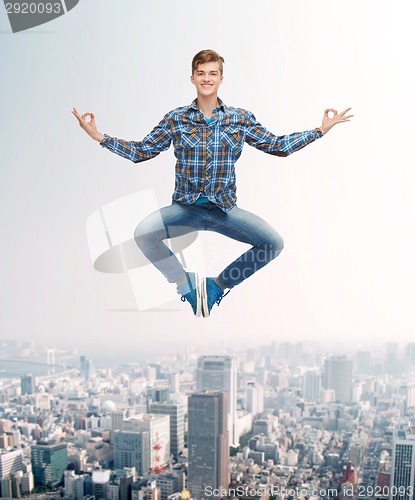 Image of smiling young man jumping in air