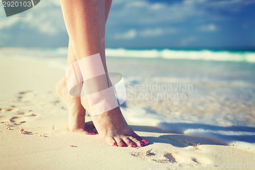 Image of closeup of woman legs on sea shore