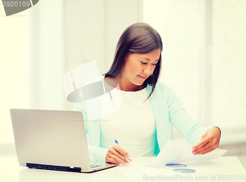 Image of asian businesswoman with laptop and documents