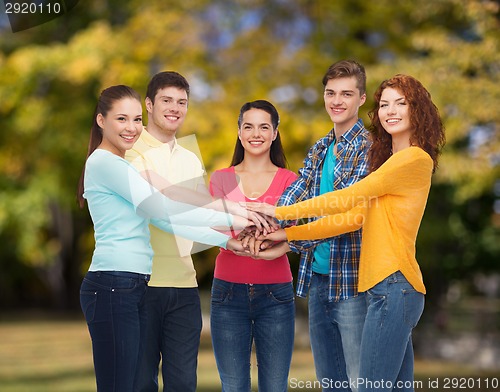 Image of group of smiling teenagers over green park