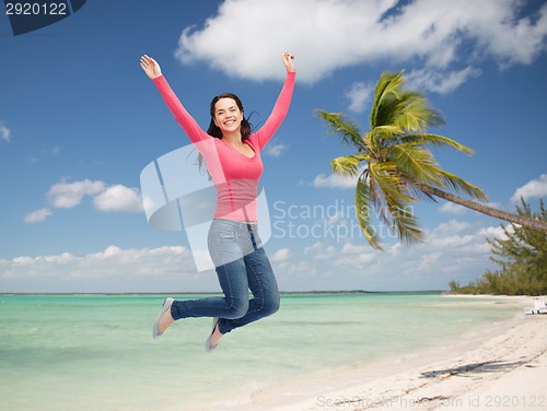 Image of smiling young woman jumping in air