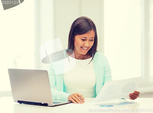 Image of asian businesswoman with laptop and documents