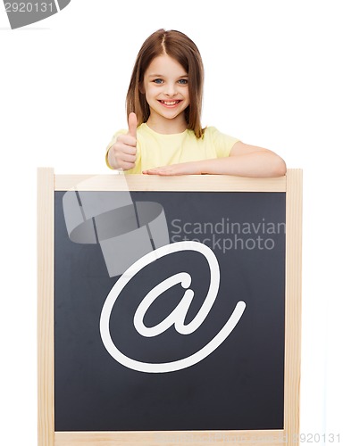 Image of smiling girl with blackboard showing thumbs up