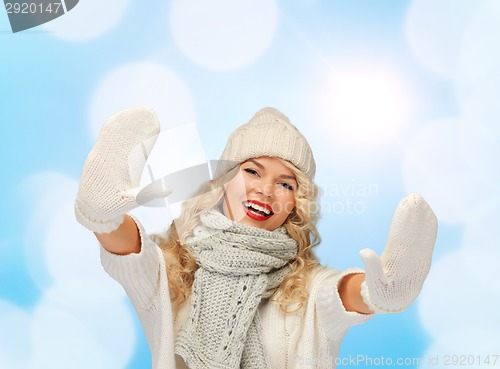 Image of smiling young woman in winter clothes