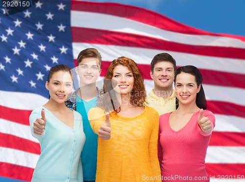 Image of group of smiling teenagers over american flag