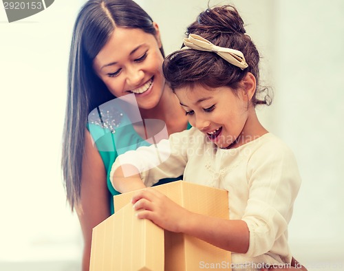 Image of happy mother and child girl with gift box