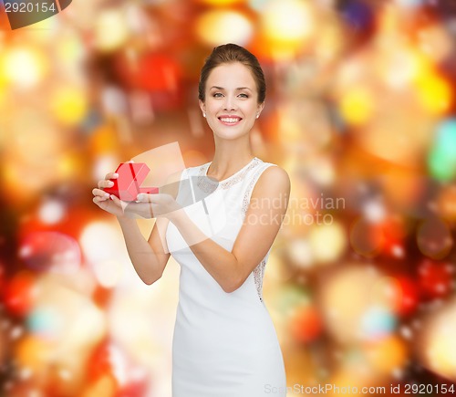 Image of smiling woman holding red gift box