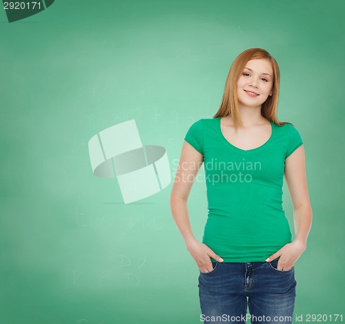 Image of smiling teenage girl over green board background
