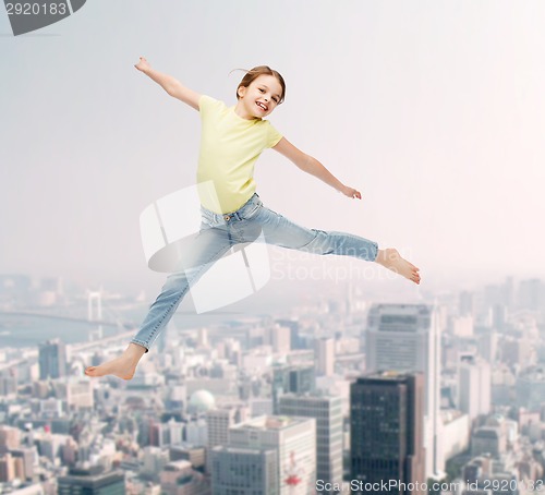 Image of smiling little girl jumping