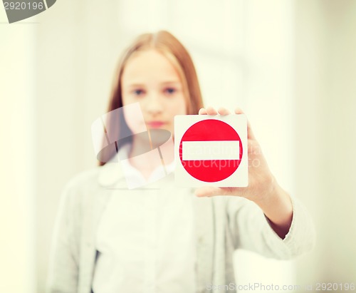 Image of girl showing no entry sign