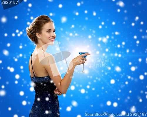 Image of smiling woman holding cocktail