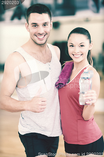 Image of two smiling people in the gym