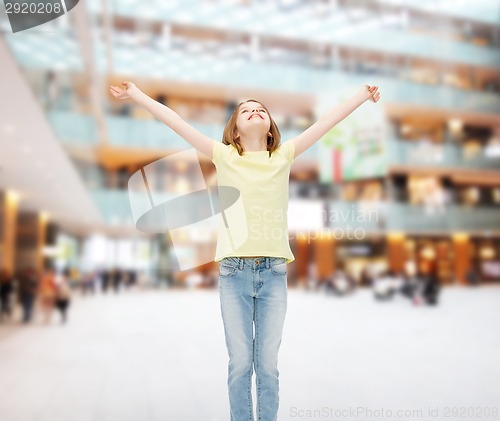 Image of smiling teenage girl with raised hands